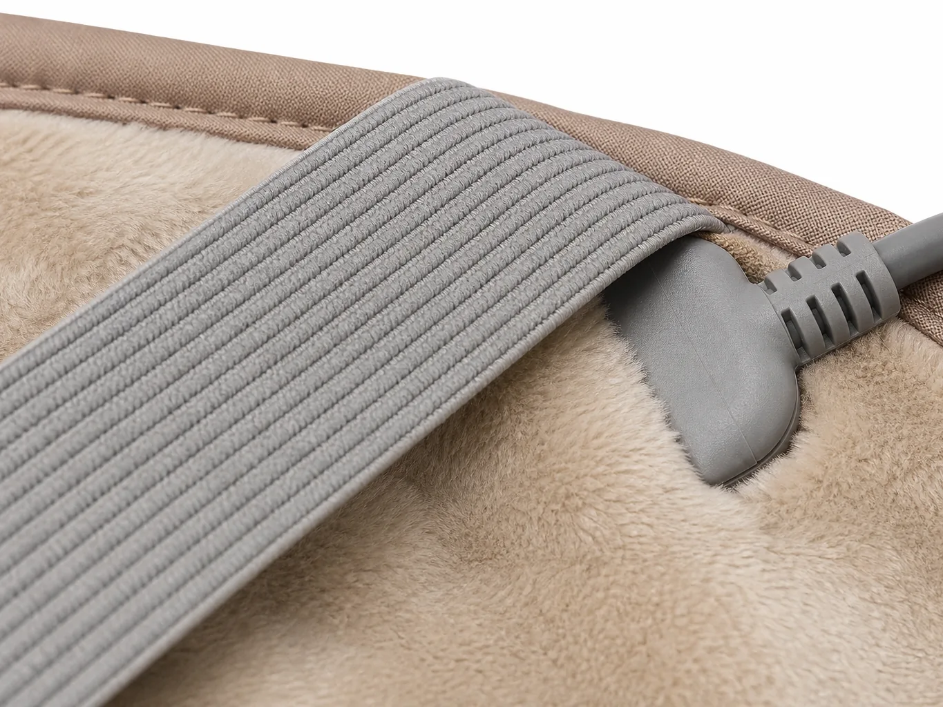 Close-up of the elastic fastener loop and the moulded strain-relief cord boot on the wrap edge