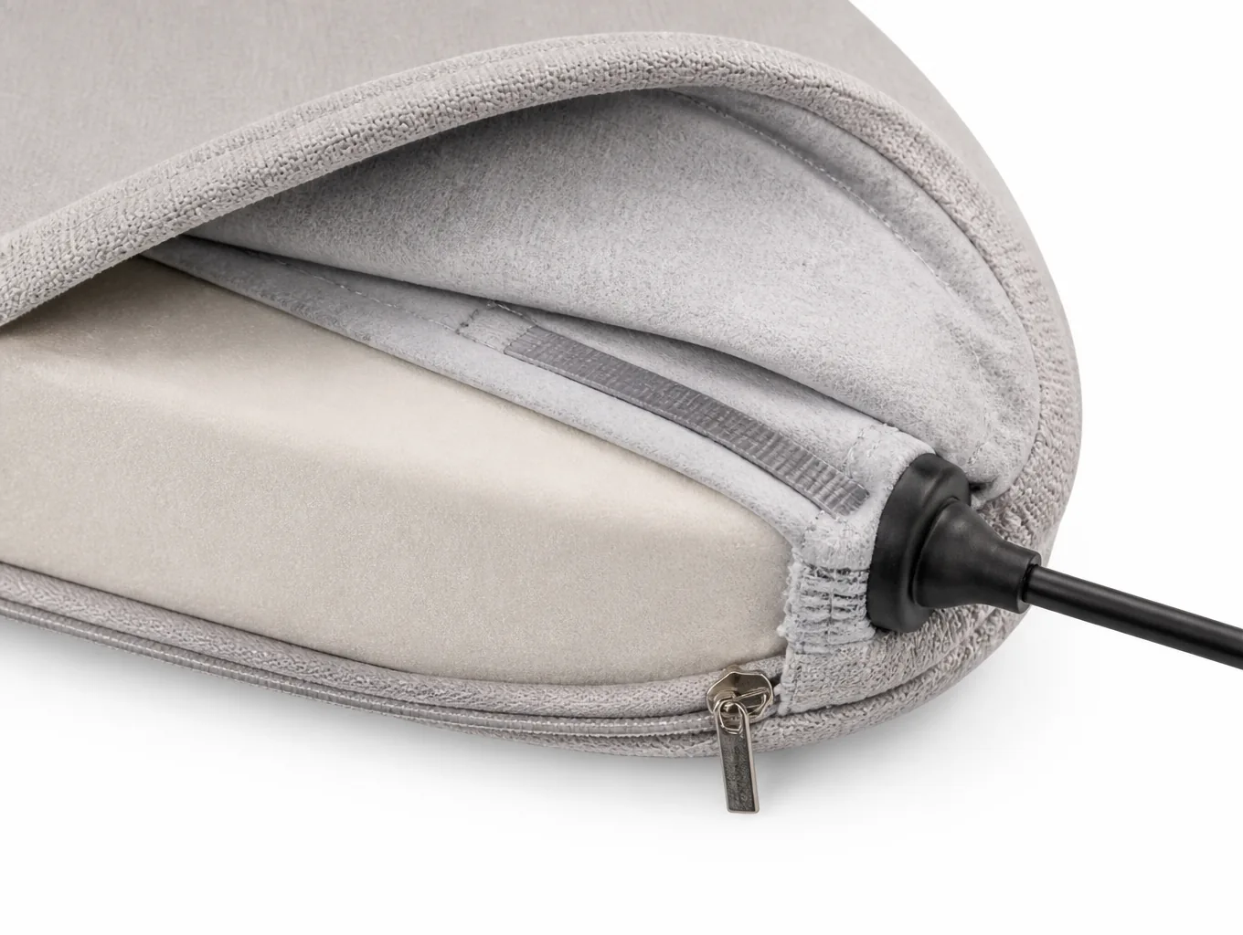 Close-up of the pillow side seam showing the foam core edge, element layer, concealed zip and cord boot