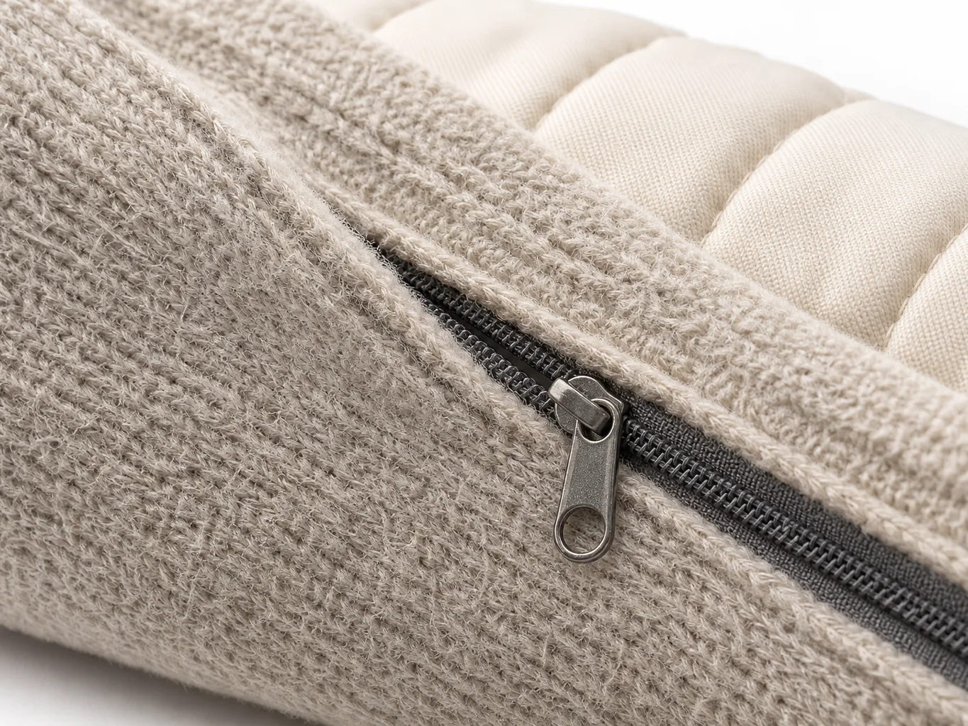 Close-up of a heated pillow cover showing the concealed zip seam and the quilted heat-pad channel