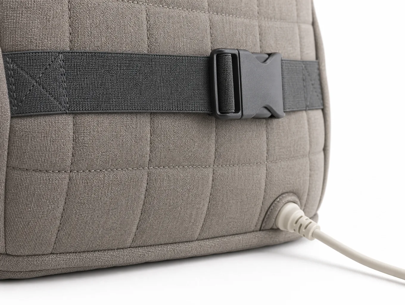 Close-up of the elastic strap and buckle on the rear panel with the cable exit