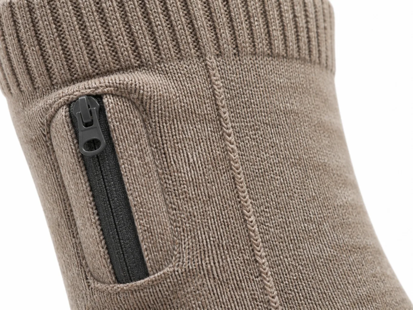 Close-up of a heated sock cuff showing the ribbed knit and the zipped battery pouch