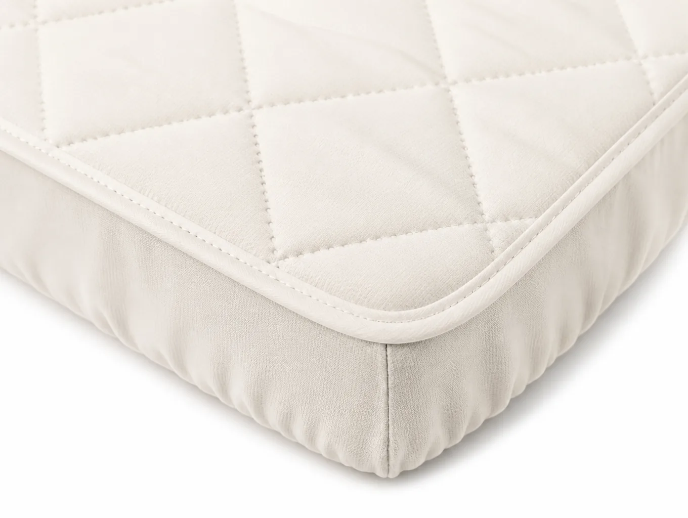 Close-up of the diamond quilt stitching, the bound top edge and the seamed elasticated corner of the skirt