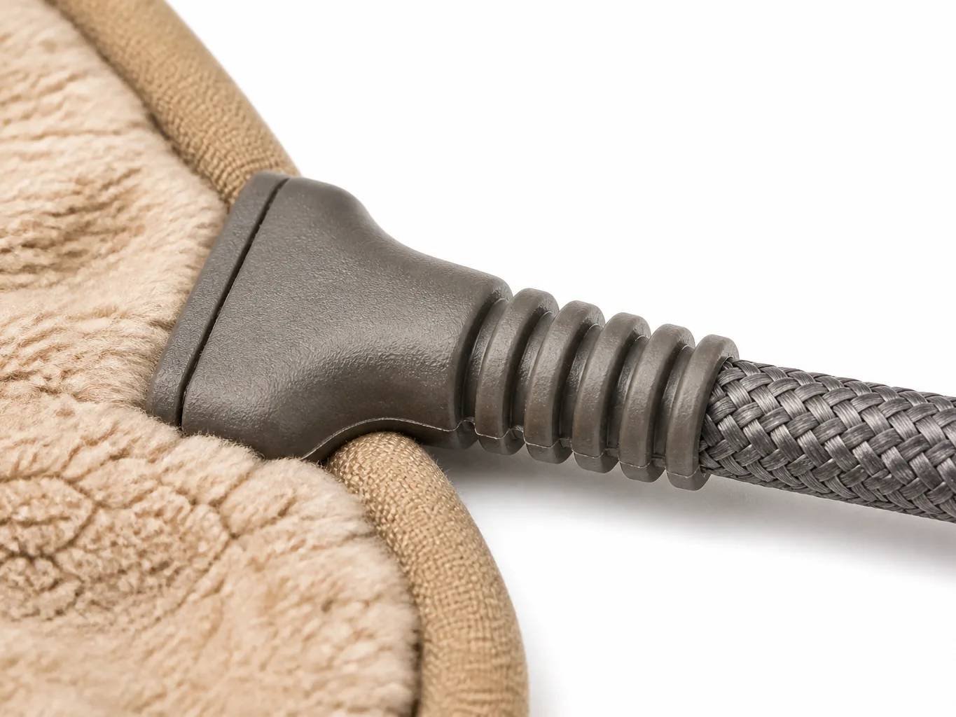 Close-up of the moulded strain-relief boot and the armoured cord where it leaves the mat edge